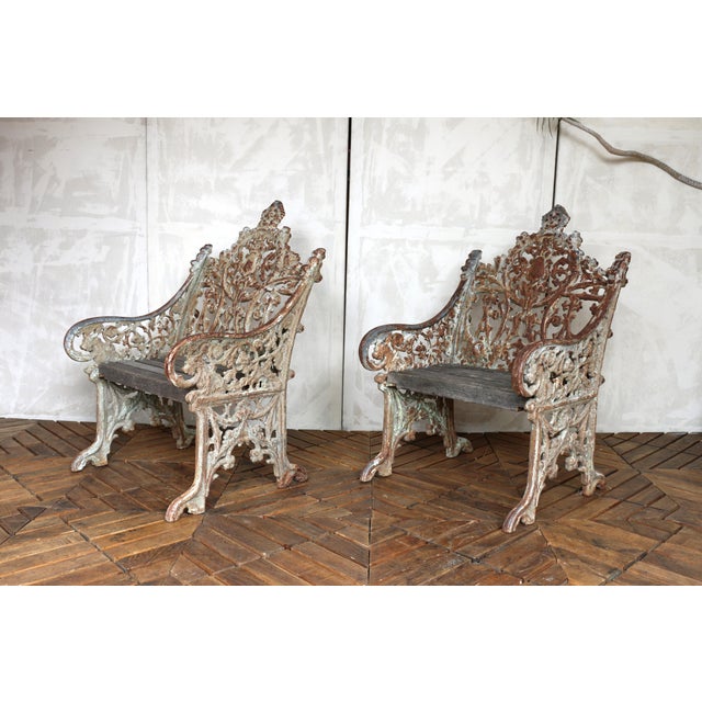 A striking and highly decorative pair of 19th century Gothic Revival cast iron garden chairs, showcasing exceptional...