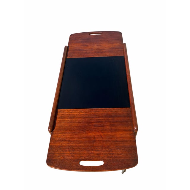 This is a “Thea” bar and serving cart, designed by Yngve Ekstrom for Kallemo in the 1960’s. Crafted from teak, the cart...