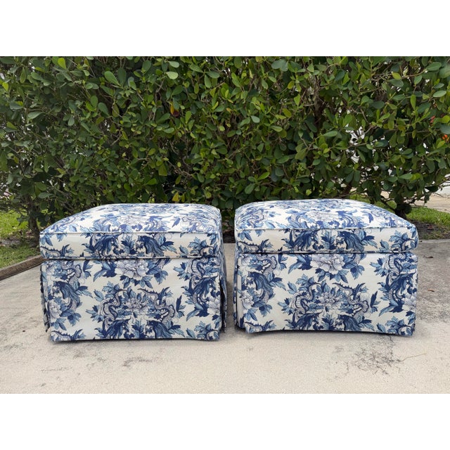 A pair of Baker upholstered ottomans featuring Ralph Lauren’s iconic Nanking Dragon fabric in a blue and white chinoiserie...