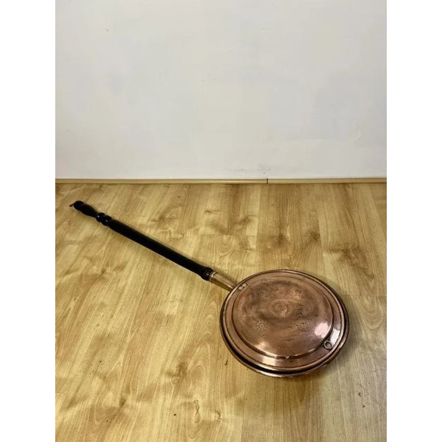 Antique George III copper warming pan having the original turned handle and a copper warming pan with engraved decoration....