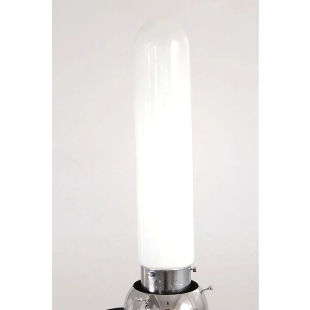 This is a table lamp from Italy in the 1960s. The lamp has a chrome-plated, spherical base with further balls as feet, the...