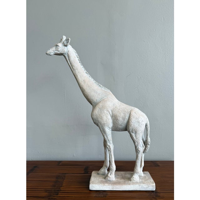 Elevate your space with this elegant and thoughtfully rendered giraffe sculpture. Cast in a textured, chalky white finish...