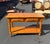 This charming knotty pine side table by Open Home features classic turned legs, warm honey-toned wood, and two functional...