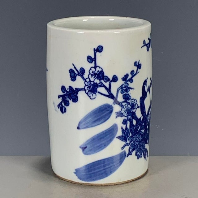 This is a charming vintage porcelain brush pot , decorated in the classic blue and white palette. The pot features a...