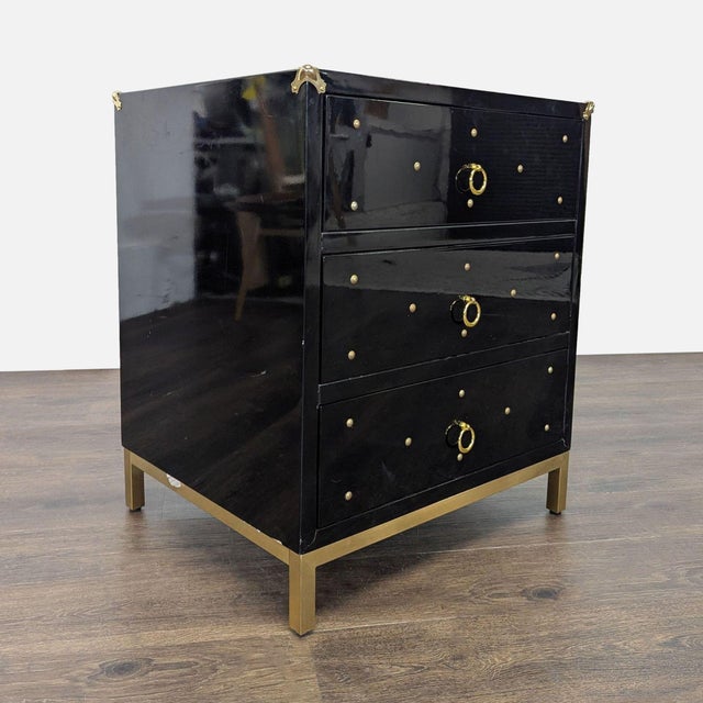 This black dresser features three spacious drawers with stylish gold ring pulls and decorative gold studs. The modern look...