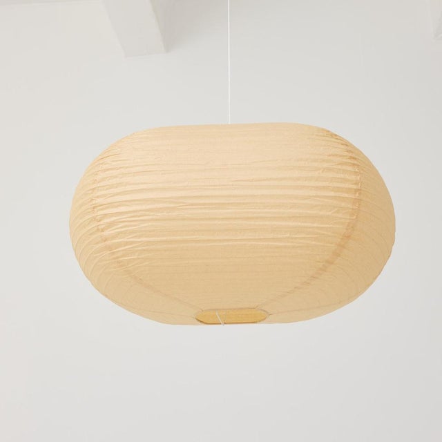 Sculptural paper pendant lamp shade in the style of Isamu Noguchi, produced by an unknown manufacturer during the 1990s....