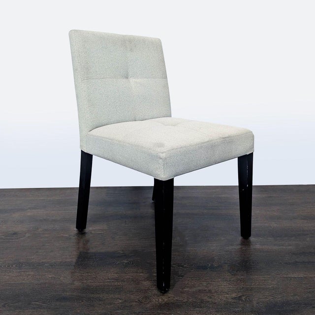 Low back chair on wood legs with button tufting Brand Crate & Barrel Dimensions 19.0ʺW x 20.5ʺD x 33.8ʺH Seat Height 17.75...