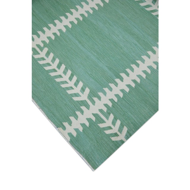 This exquisite Turkish flatweave kilim rug is a stunning masterpiece of traditional craftsmanship. Each rug is...