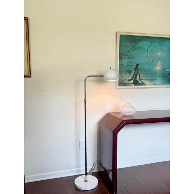 Vintage space age adjustable chrome floor lamp with white accents, circa 1970s. A striking example of mid century...