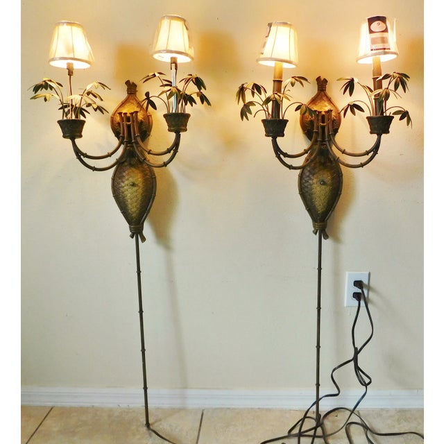 Beautiful pair of large vintage Palm Beach Regency tole and resin two arm palm tree wall sconces. Beautiful design. They...