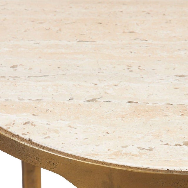 Refined organic elegant side table with warm brass-finished aluminum framework and natural travertine shelving. The...