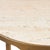 Refined organic elegant side table with warm brass-finished aluminum framework and natural travertine shelving. The...