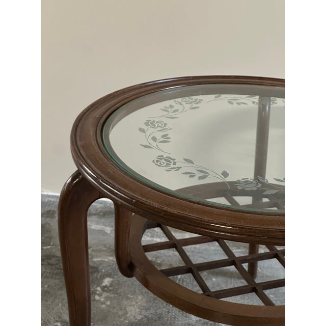 Round coffee table, 1950s, Italian-made, in the style of Paolo Buffa. Round wooden frame, original glass top with engraved...