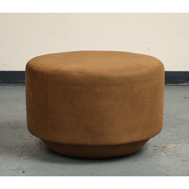 Pair of brown suede round ottomans/poufs, the "Mohave" by Nate Berkus + Jeremiah Brent for Living Spaces. Wood base. Made...