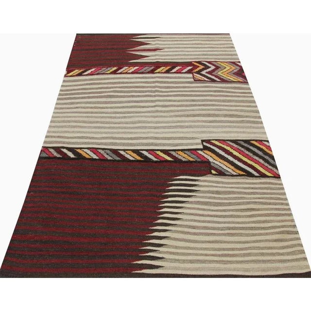 This bewitchingly beautiful example of a tribal Kilim area rug features a contemporary pop of electrifying bright colors...
