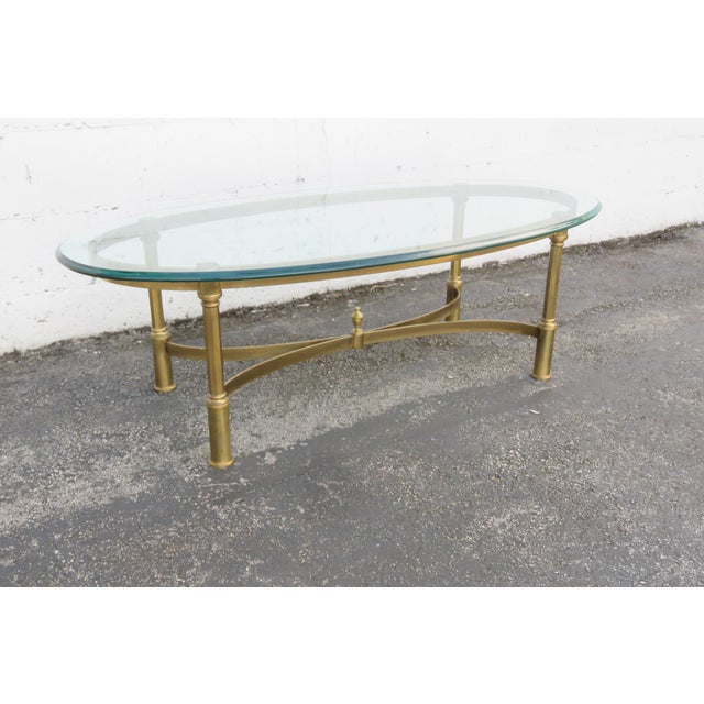 This beautiful Coffee Table made of metal, and glass. The Coffee Table has a Hollywood Regency style and design, brass...