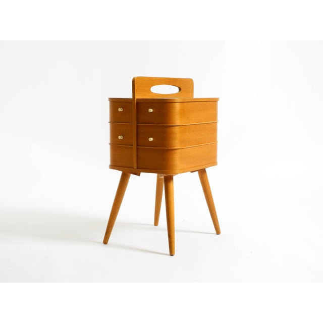 Original Mid Century Modern folding sewing box in very good vintage condition. The entire box is made of plywood with teak...