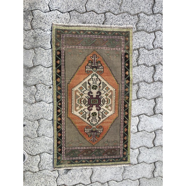 This is a vintage Turkish Oushak rug from the 1960s. The piece was hand-knotted.