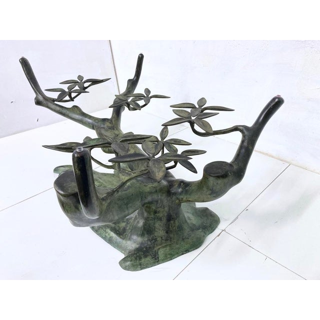 1 coffee table from the 1970s/80s. Sculptural metal frame, glass top. Good used condition. One chip in the glass top (see...