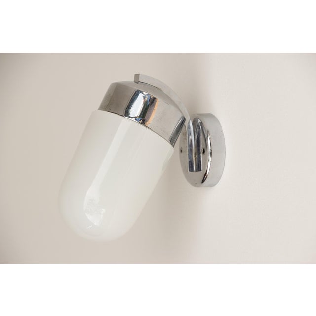 Small wall lamp, made in Germany in the 1920s. Opal glass shade with screw mounting on a chrome-plated or nickel-plated...