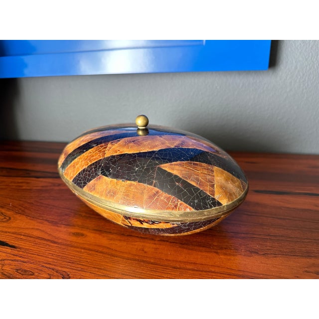 Maitland Smith decorative jewelry box made of two tone tessellated pen shell with brass detailing.