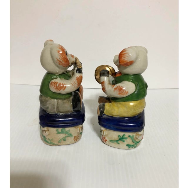 An adorable set of antique 1920s ceramic musical pigs, one playing a flute and the other cymbals, in the Staffordshire...
