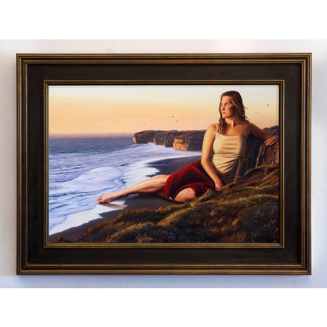 The artwork depicts a serene figure reclining on a cliffside, gazing thoughtfully at the expansive seascape below. The...