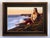 The artwork depicts a serene figure reclining on a cliffside, gazing thoughtfully at the expansive seascape below. The...