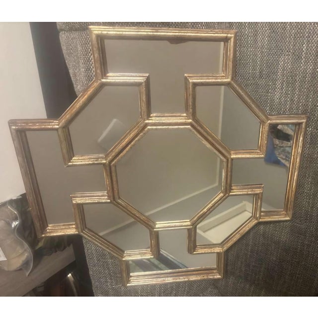 Architectural geometric wall mirror composed of multiple mirrored panes arranged in a stylized honeycomb / octagonal...