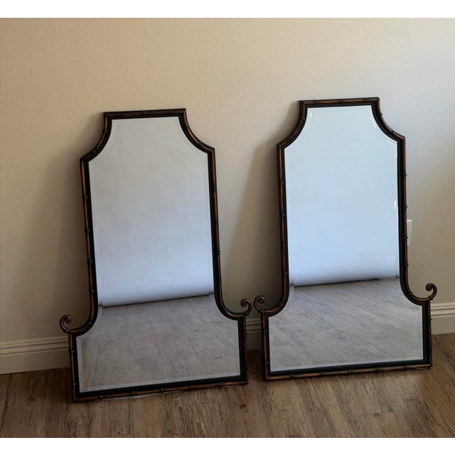 Elevate your home with this elegant pair of Uttermost faux bamboo pagoda wall mirrors, each retaining its original...