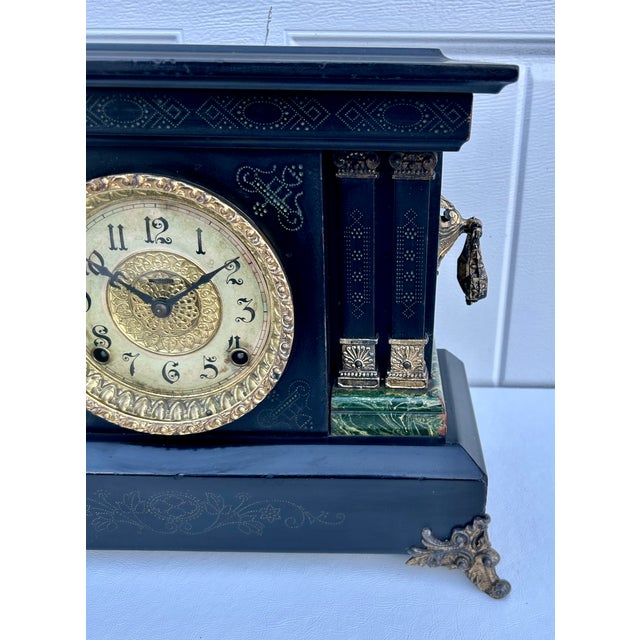 Antique (1880's) Mantel Clock has a Victorian Style. Made by E. Ingraham "ADRIAN". Wood Casing. Black Finish with Faux...