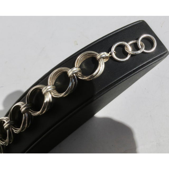 Marked on the toggle 925 and INDIA. Each link is composed of 5 links joined by a smaller double band. A design of braided...