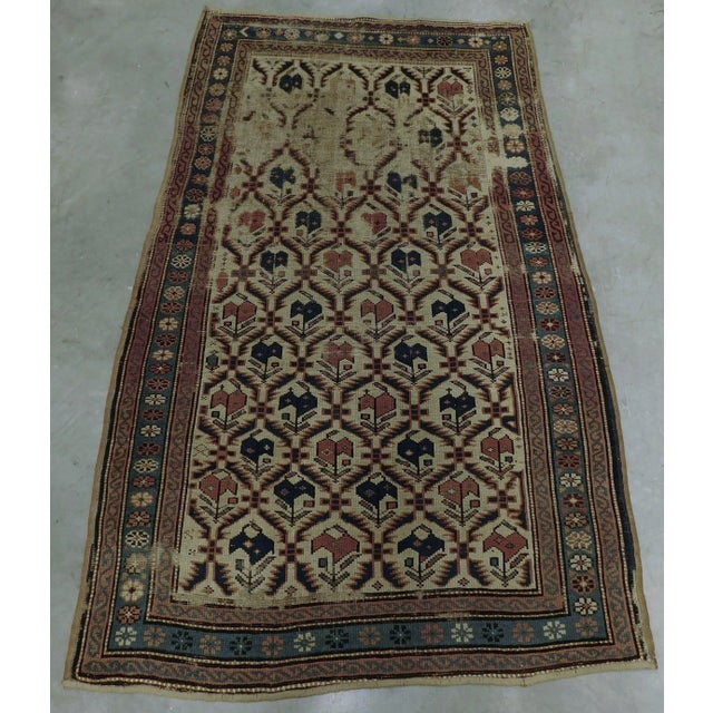 Distressed antique Caucasian rug. Intricate lattice pattern. Wool pile. Hand-knotted.