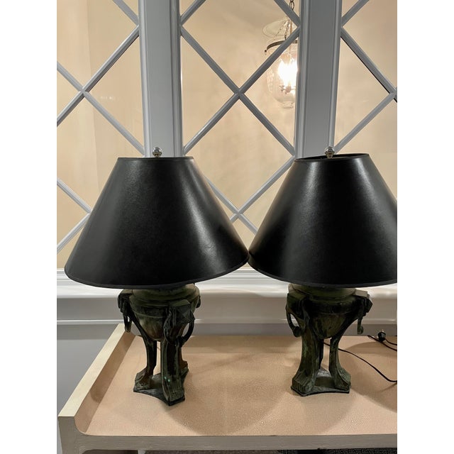 Neo- classical metal lamps with weathered verde green metal finish. Comes in a set of two with black lampshades.