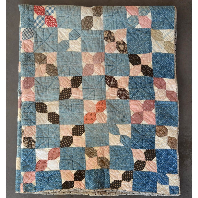 Hand-stitched and hand-quilted, made with tiny indigo prints, checks, florals, and others. It is a medium-weight quilt...