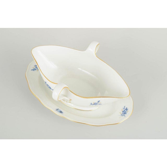 Meissen Sauce boat with fixed undertray, early 20th century. Hand-decorated porcelain with hand-painted blue floral motifs...