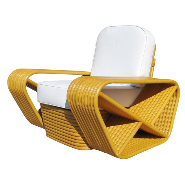 Paul Frankl style rare ten-strand square pretzel rattan lounge chair with stacked rattan base. The chair features the...