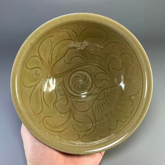 This exquisite Northern Song Dynasty (960–1127 CE) Longquan celadon carved bowl is a fine example of China’s iconic...