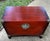 This striking Chinese red lacquered trunk features authentic round brass hardware and a traditional medallion lock that...