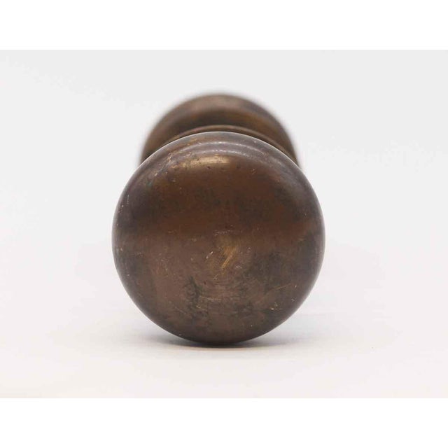 Plain round bronze door knob set with a dark antique patina. The manufacturer is unknown. Priced as two door knobs, two...