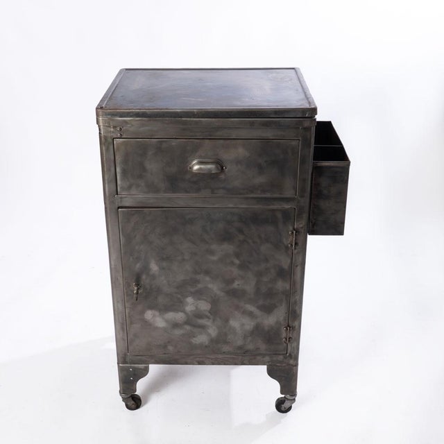 Industrial Steel Cabinet with casters. Top drawer, side tray and bottom cabinet. Top rotates to the left. Good piece for...