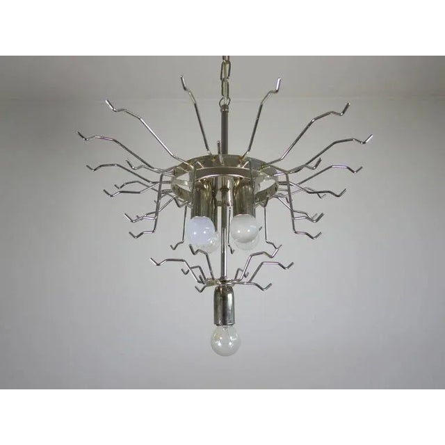 Huge Italian vintage Murano chandelier made by 42 glass petals (transparent and white “lattimo”) in a chrome frame....