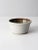 This is a vintage studio pottery bowl. Signed by the artist, the handmade bowl has a striking speckled glaze in white and...