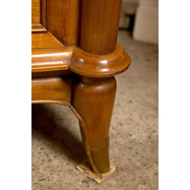 The long rectangular top with serpentine front above three pairs of cupboard doors opening to drawers and shelves and...