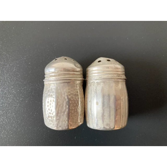 A vintage sterling silver charming salt and pepper shaker set. Petite and stout, they stand behind one's dish just waiting...