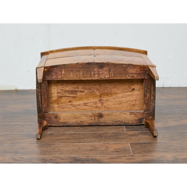 This English 19th-century mahogany bow front chest offers a striking balance of refinement and warmth, showcasing a...