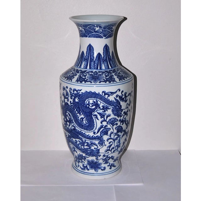 An elegant vase showing a powerful dragon hovering around the magical pearl An elegant porcelain Chinese Export bottle...