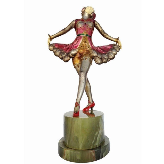 A superb spelter metal and Ivorine sculpture, this piece serves as a great example of early Art Deco statues made popular...
