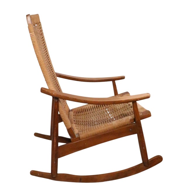 Classic mid century high back woven rope rocker, executed in the manner of Hans Wegner. This example is in good, original...