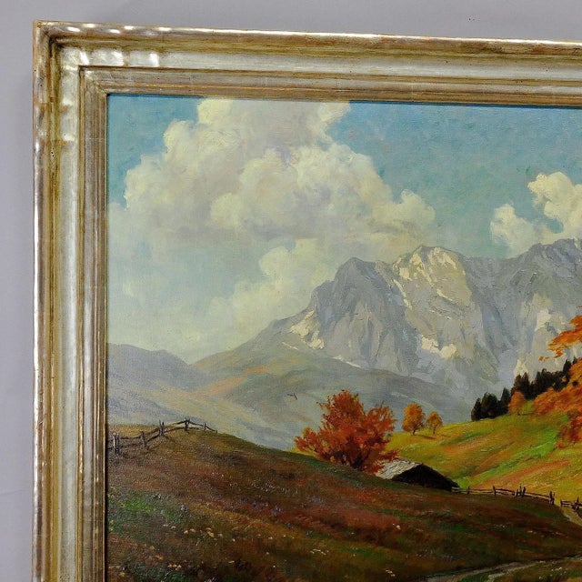 An original antique painting showing alpine meadows with mountains in the background. oil on canvas, painted and signed by...